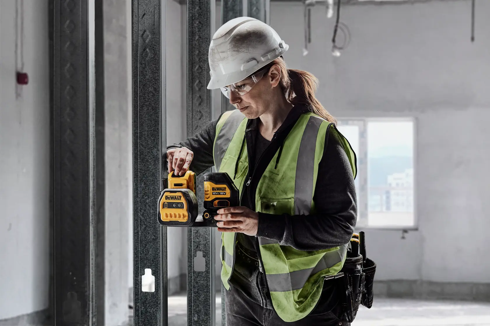 Worker uses DEWALT DCE088D1G18-QW and DCE088D1G18 in construction. Photography product category.