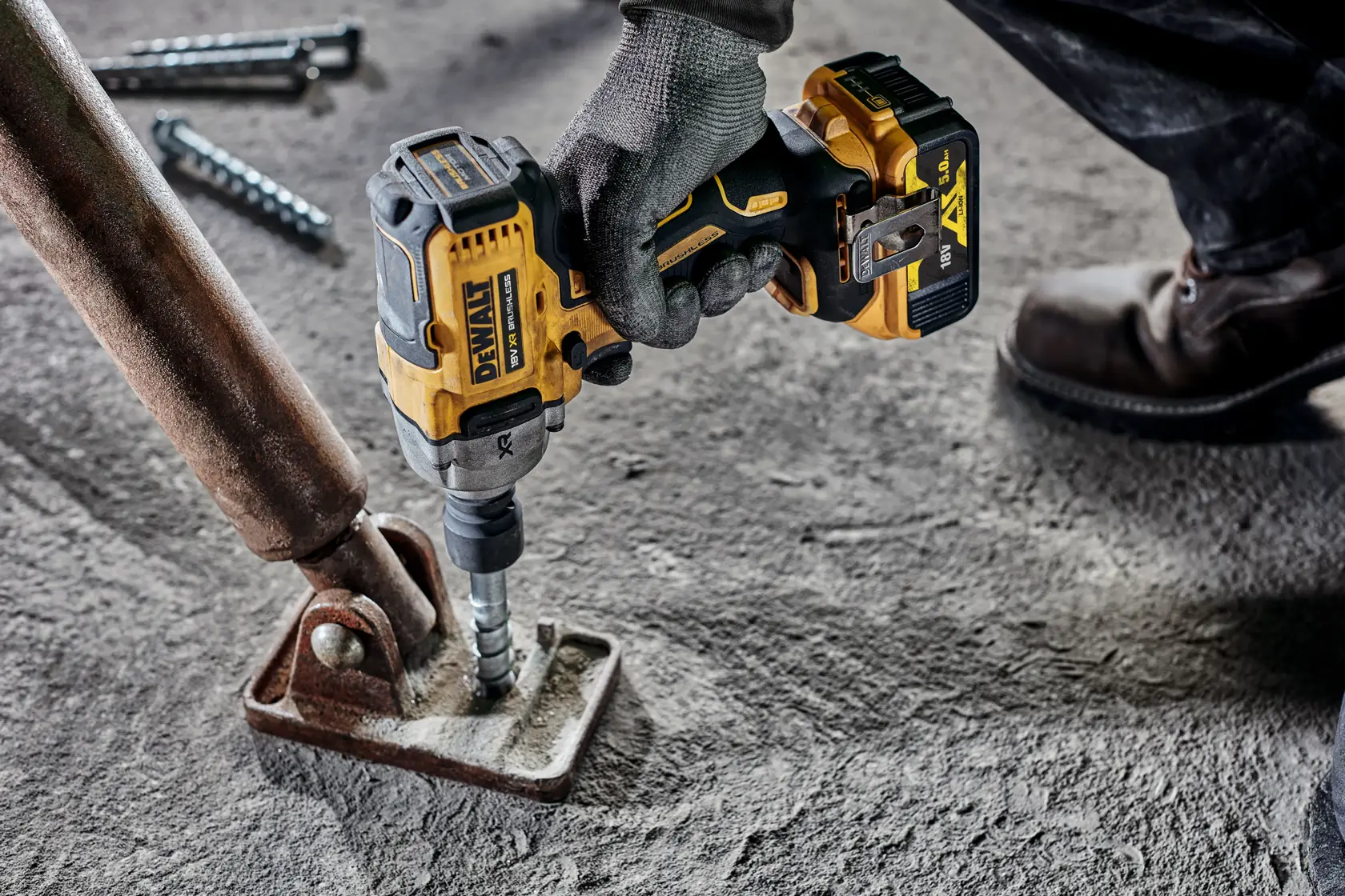 DEWALT drill used on metal, SKUs DCF892N and DCZ407P1T1-XE shown. Construction setting, close-up photo.