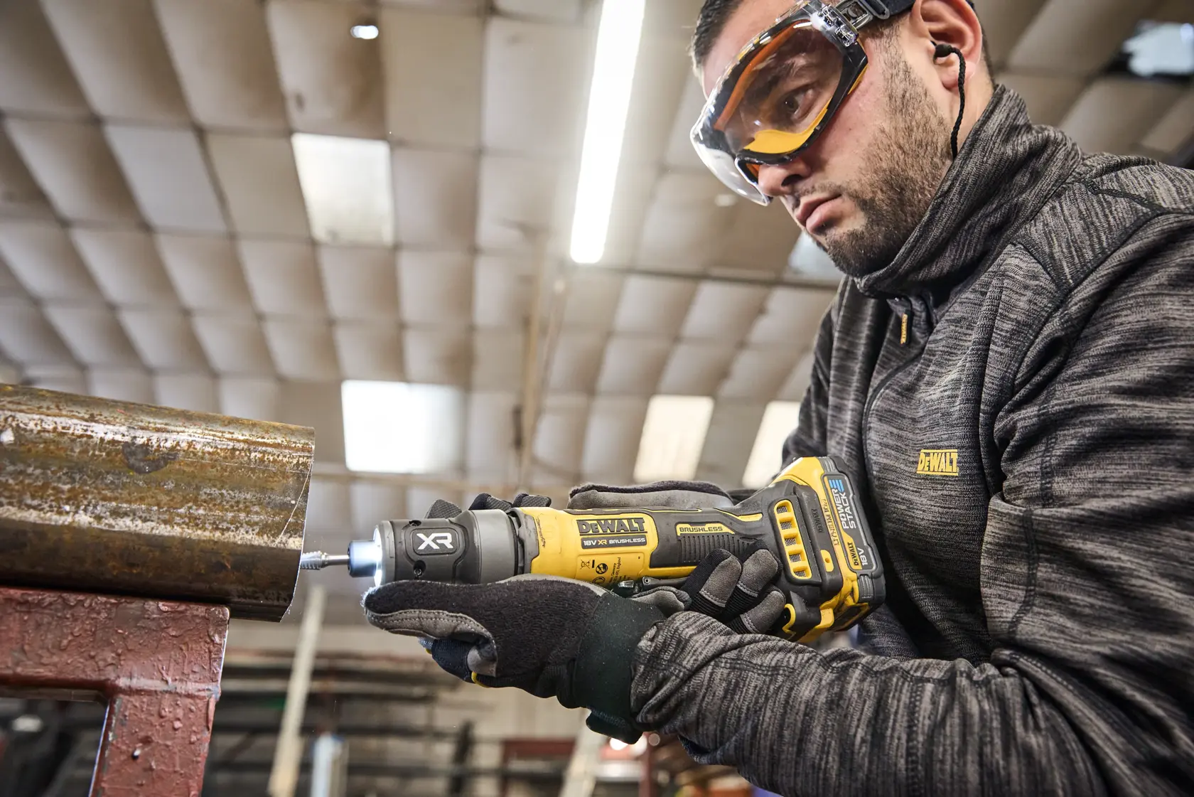 DEWALT DCG420N-XJ, DCG420N tool in use on metal pipe. User in DEWALT gear. Photography category.