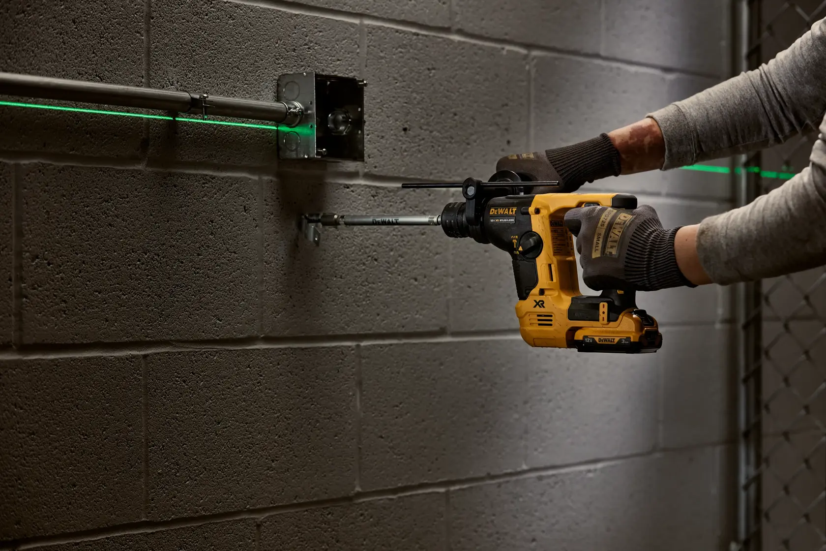 DEWALT tool in use drilling wall. SKUs: DCH072NT, DCH072N, DCH072N-XJ. Photography product category.