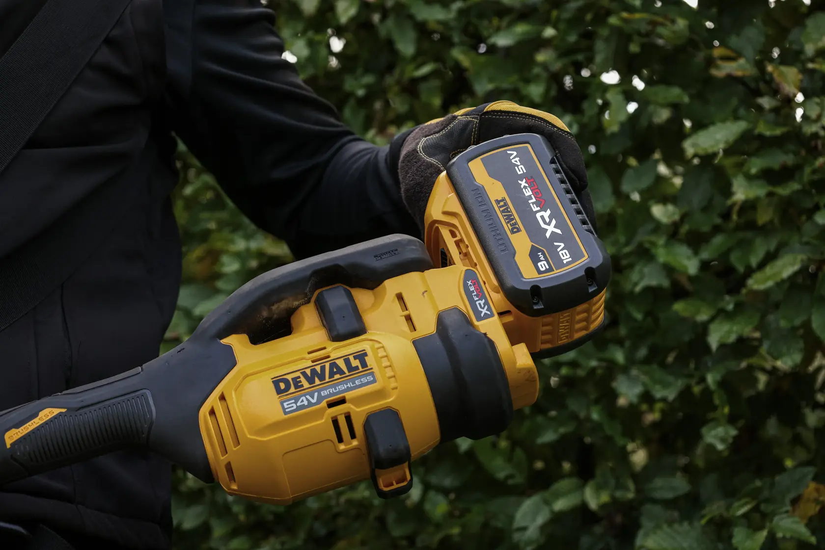 DEWALT tool in use outdoors. SKUs: DCMASPH6N, DCZ65713X1-XE, DCMASPH6N-XJ. Photography category.
