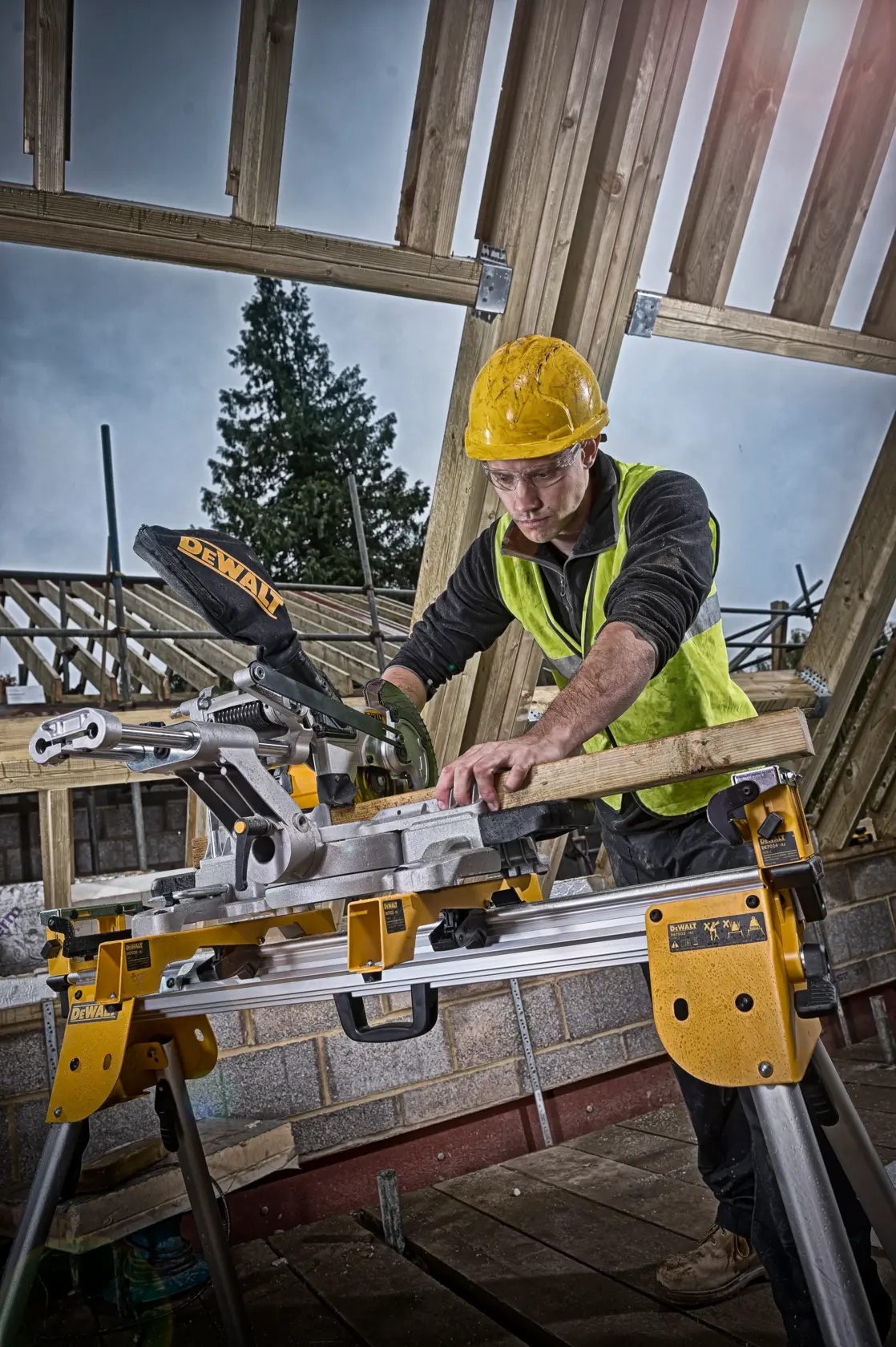 Arbeiter schneidet Holz mit DEWALT DCS365N Säge auf Baustelle mit Holzrahmen.