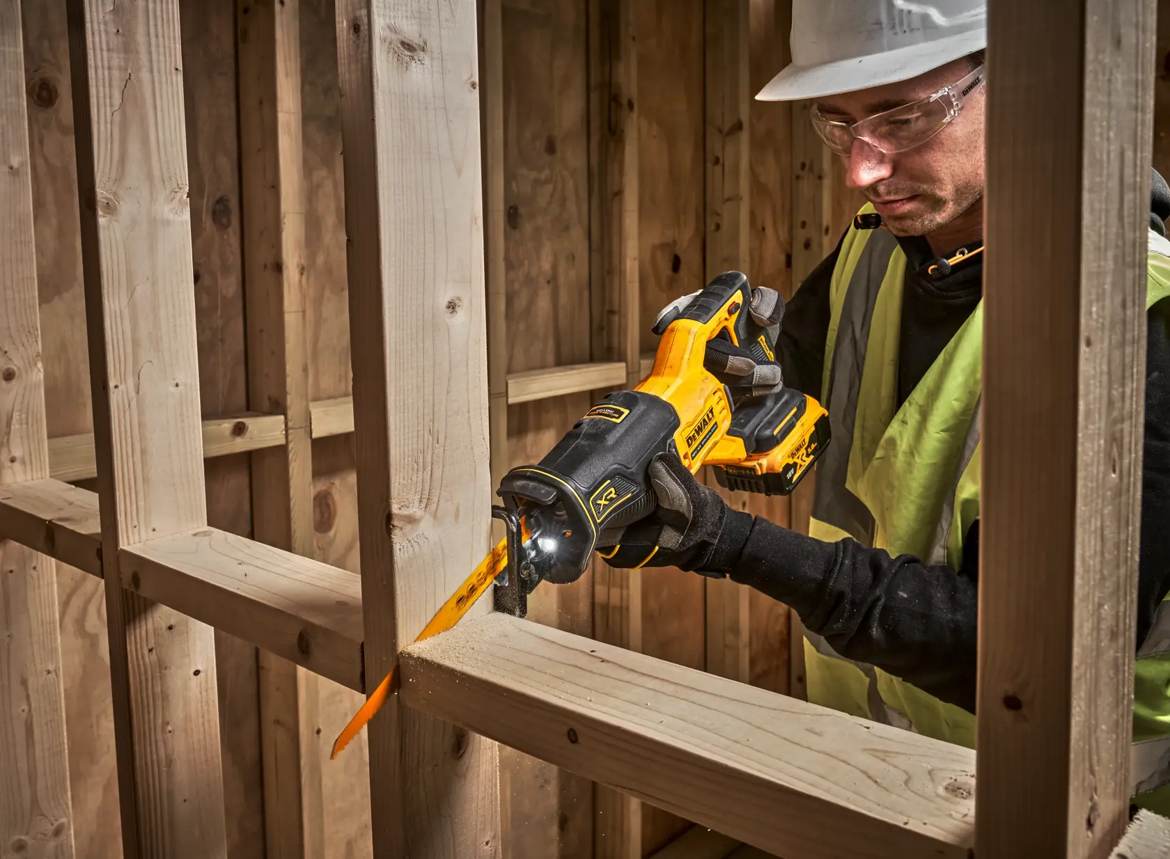 DEWALT DCS382N, DCS382N-XJ saw in use cutting wood at a construction site.