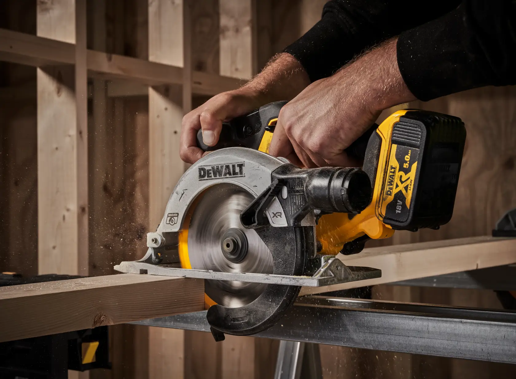 DEWALT cordless circular saw cutting wood plank in a workshop with hands operating the tool.