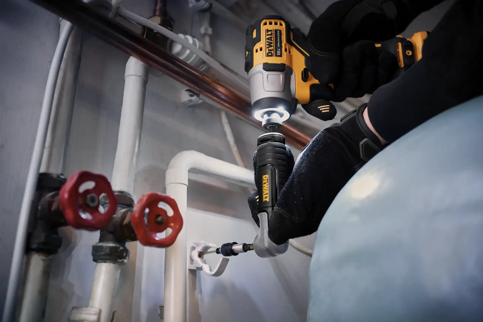 DEWALT DT20500 attachment used with a drill for work on pipes and valves in an industrial setting.