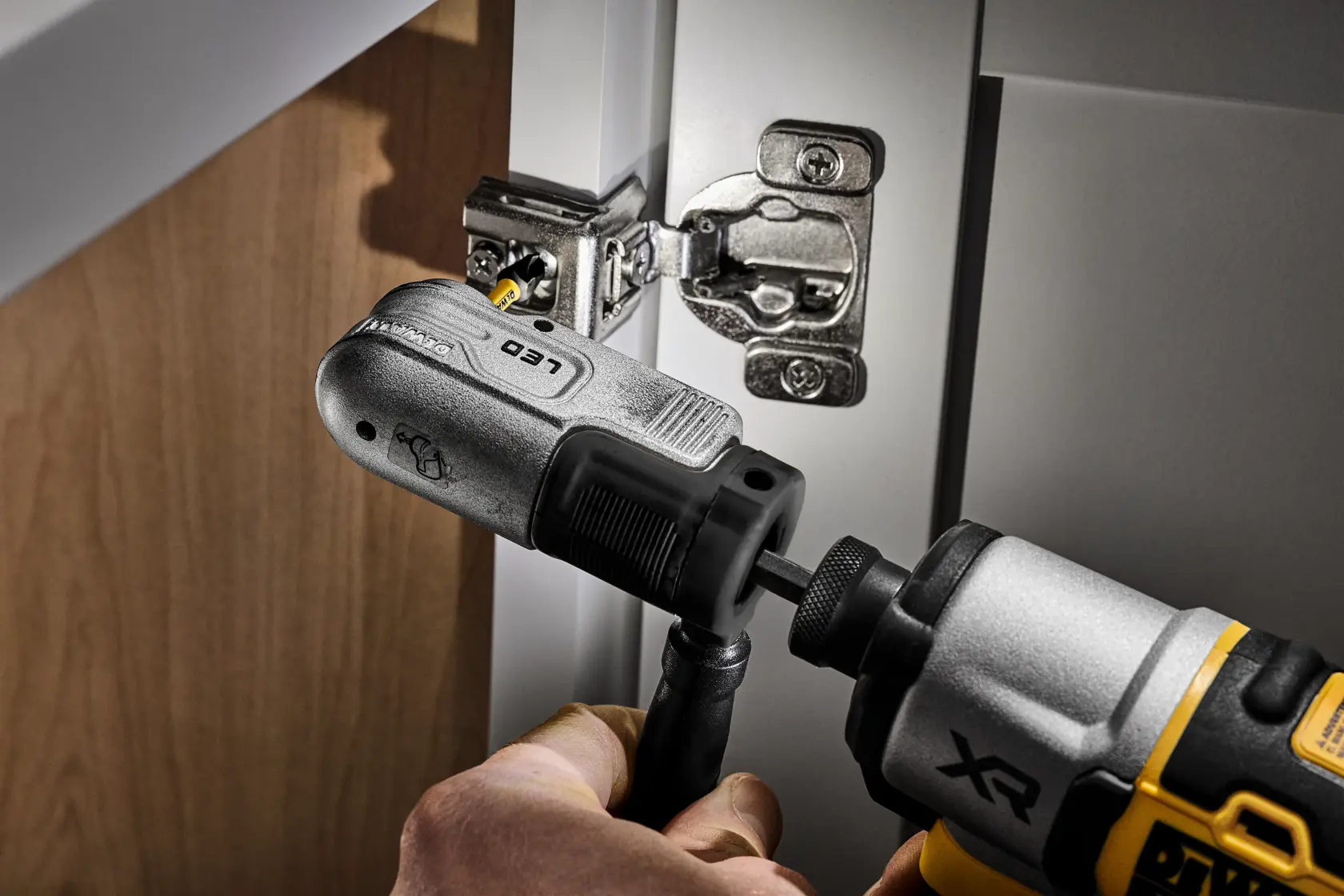 DEWALT right angle attachment used with a drill to install a cabinet hinge in tight space.