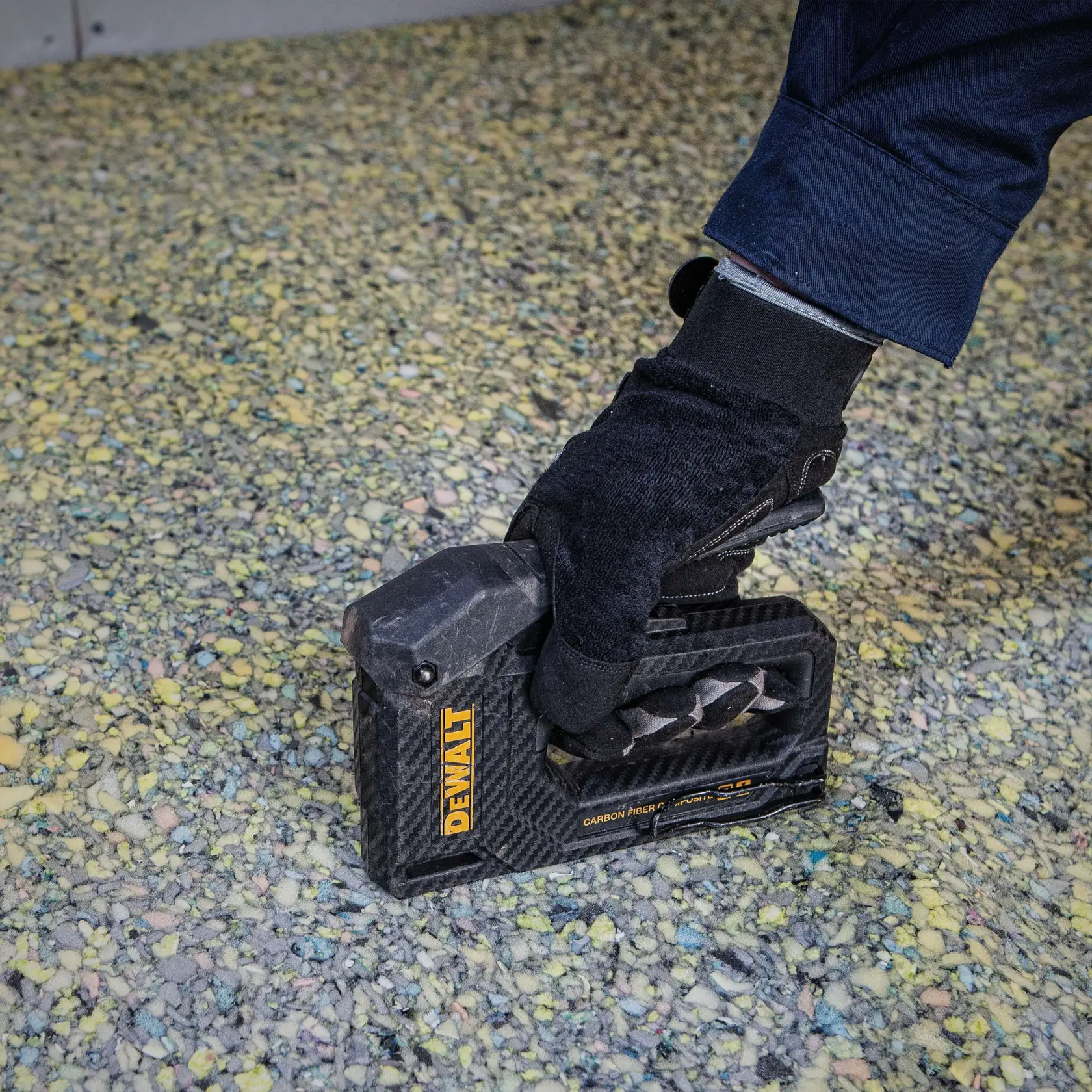Close up of  Carbon Fiber Composite Staple Gun being used to staple material.
